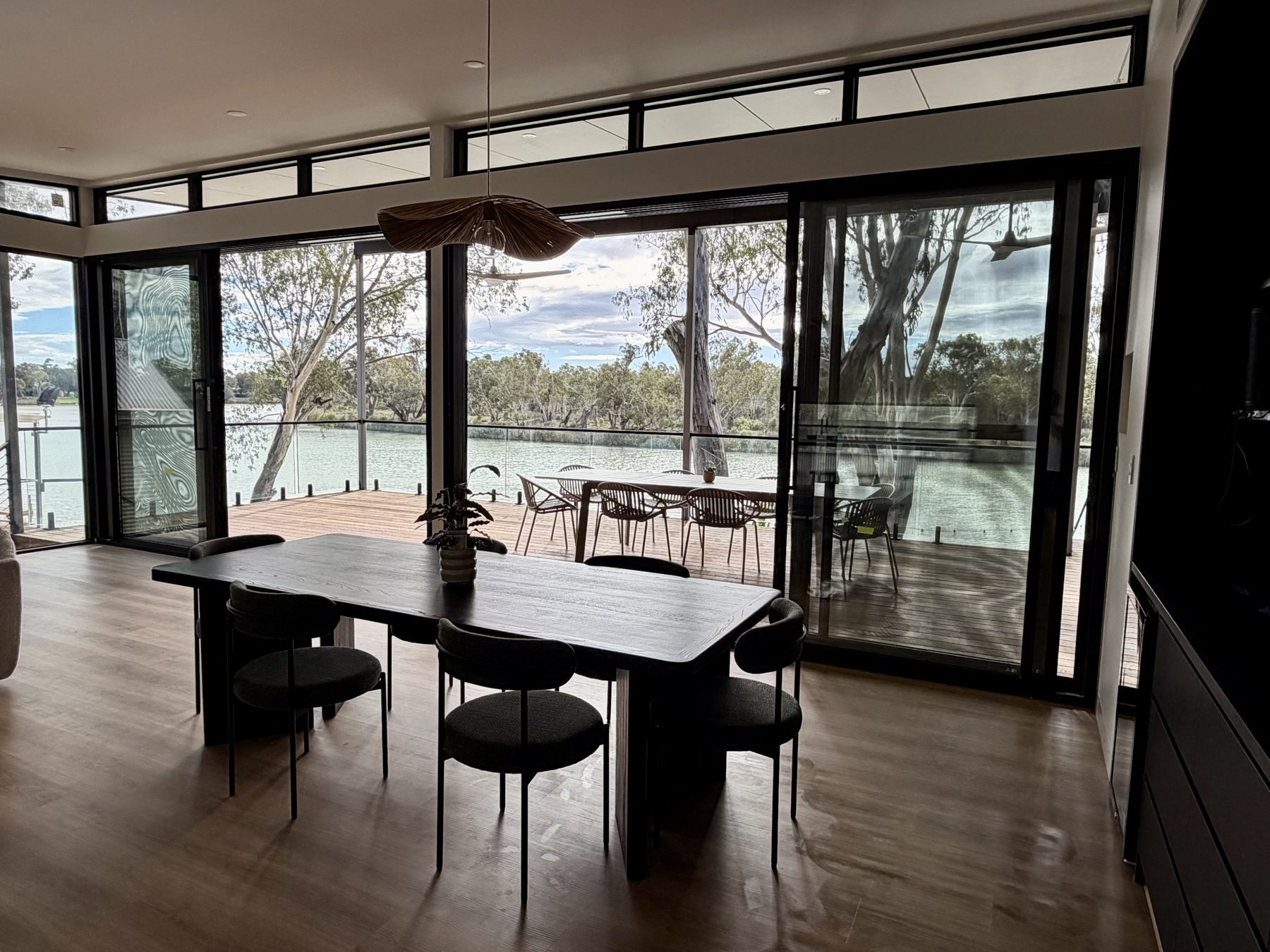 Dining room with floor-to-ceiling river views
